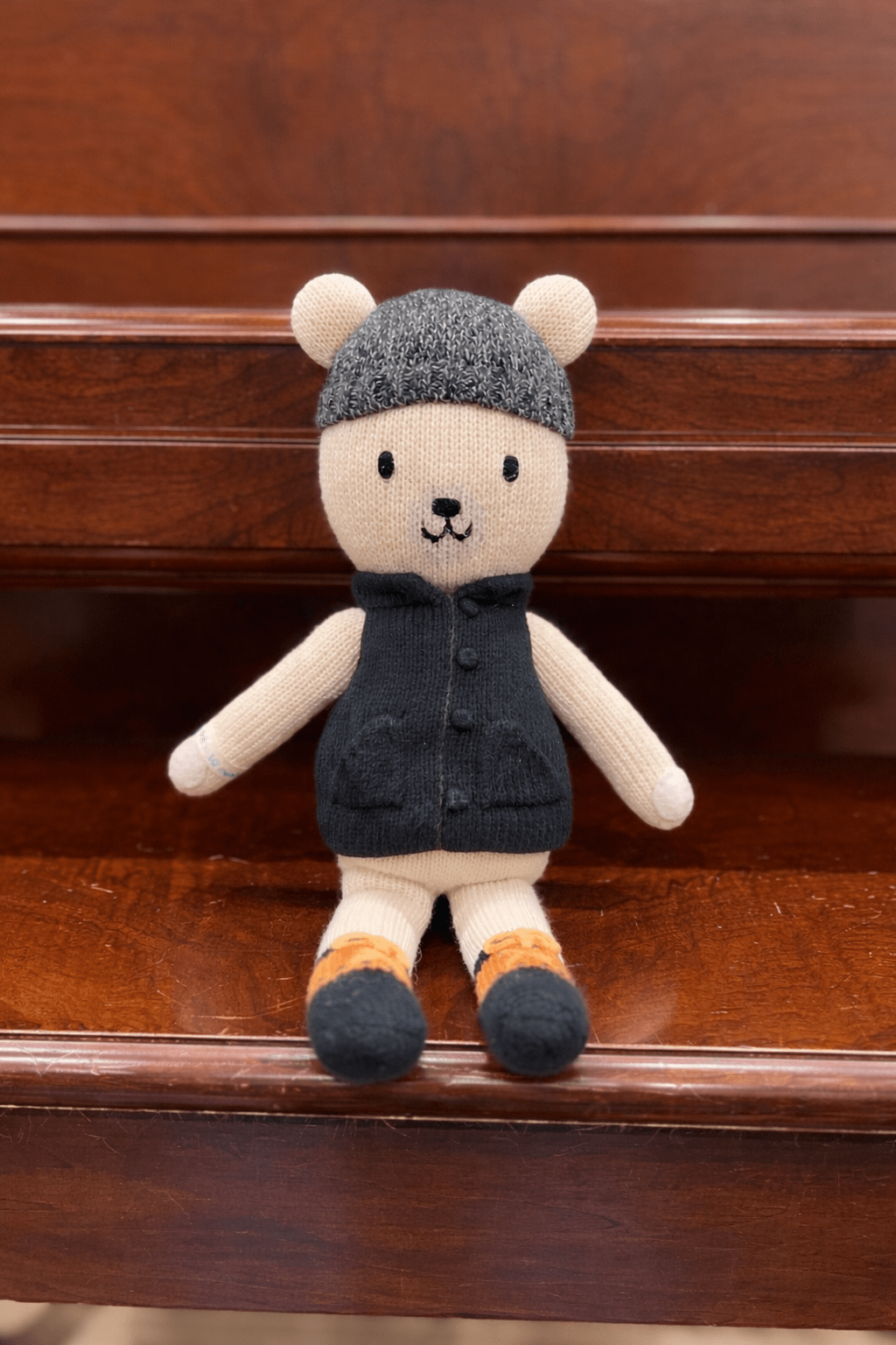 Hudson the Bear sitting on a piano bench